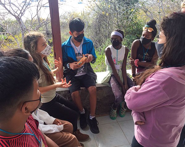 group of young adults sitting in a circle