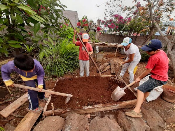 children using garden tools to create a plant box