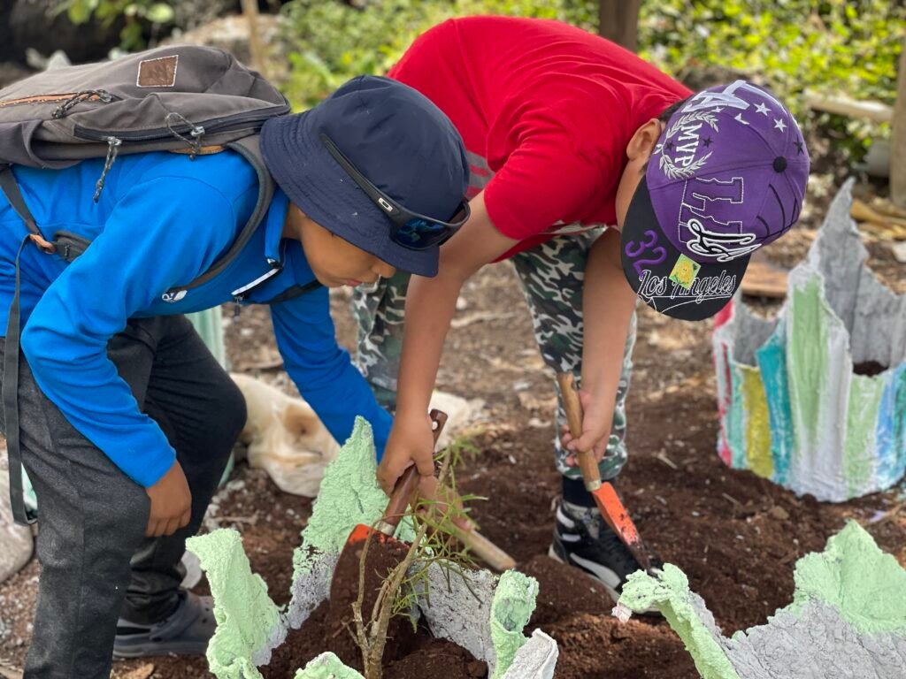 two children repotting plants